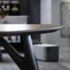 Detailed close-up of the Ted Nero dining table, highlighting the fine craftsmanship and elegant finish of the dark wood surface.