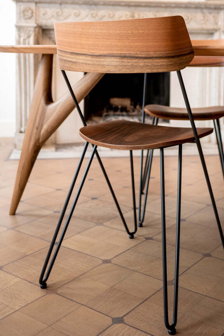 Close-up of the Ibsen Comfort Chair by Greyge in walnut, showcasing minimalist design and fine craftsmanship